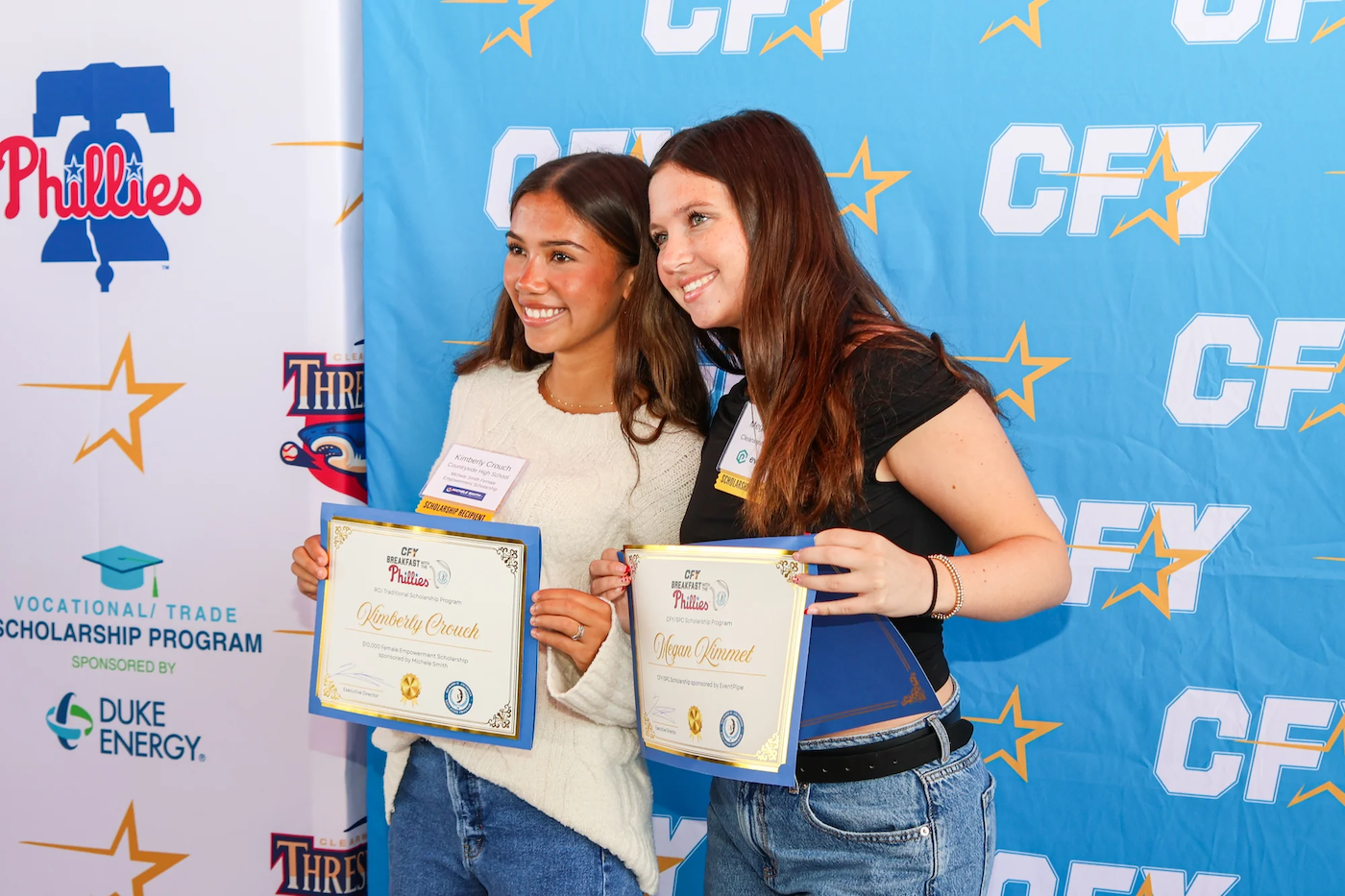 CFY scholarship recipients posing with award certificates at scholarship recognition event sponsored by the Phillies and Duke Energy.