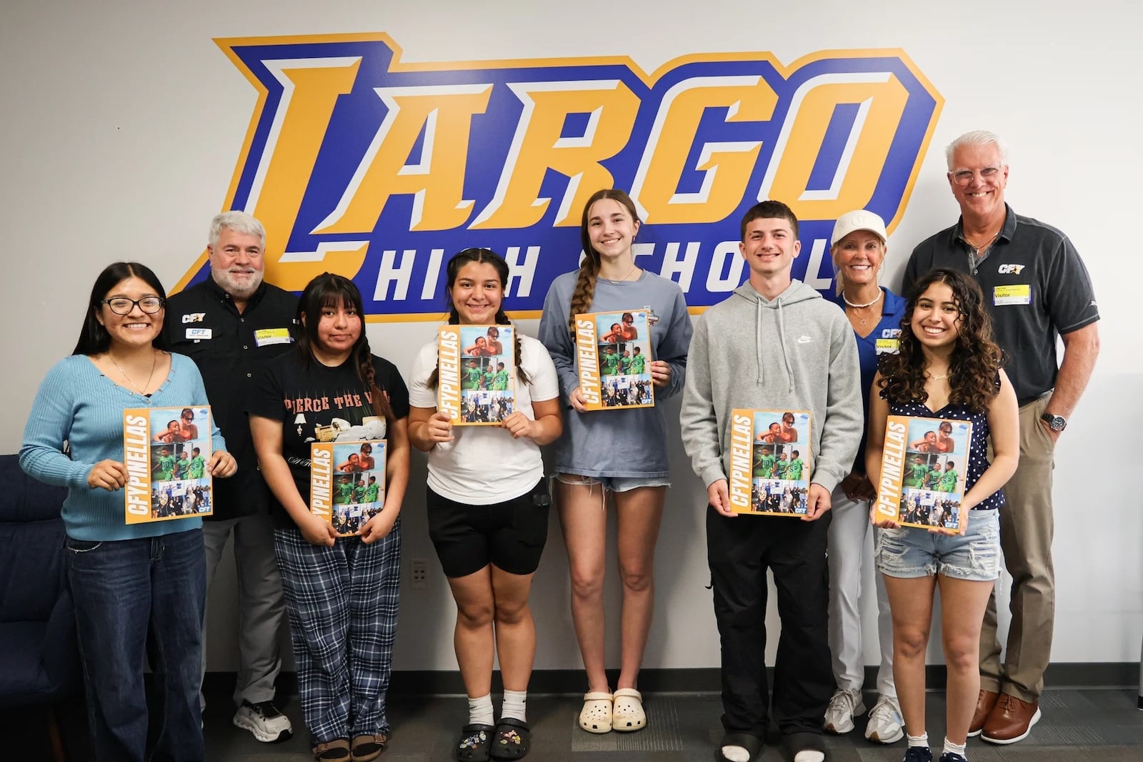 Largo High school students and CFY members posing with CFY's poster