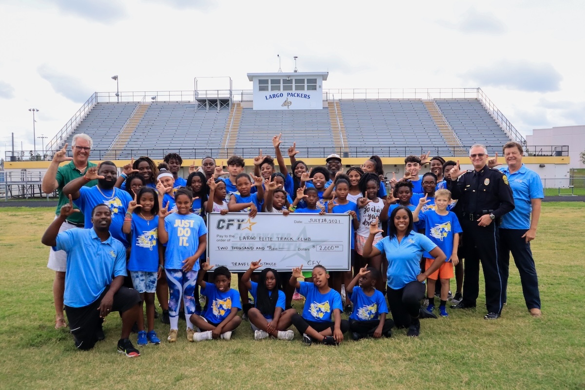 An image of students holding up a grant for more CFY Pinellas County Youth opportunities