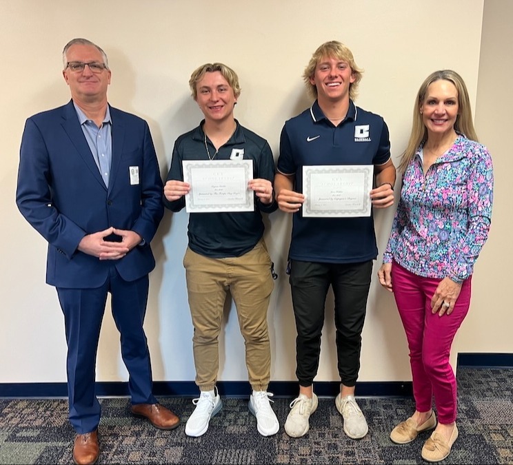 Student scholarship recipients holding diploma