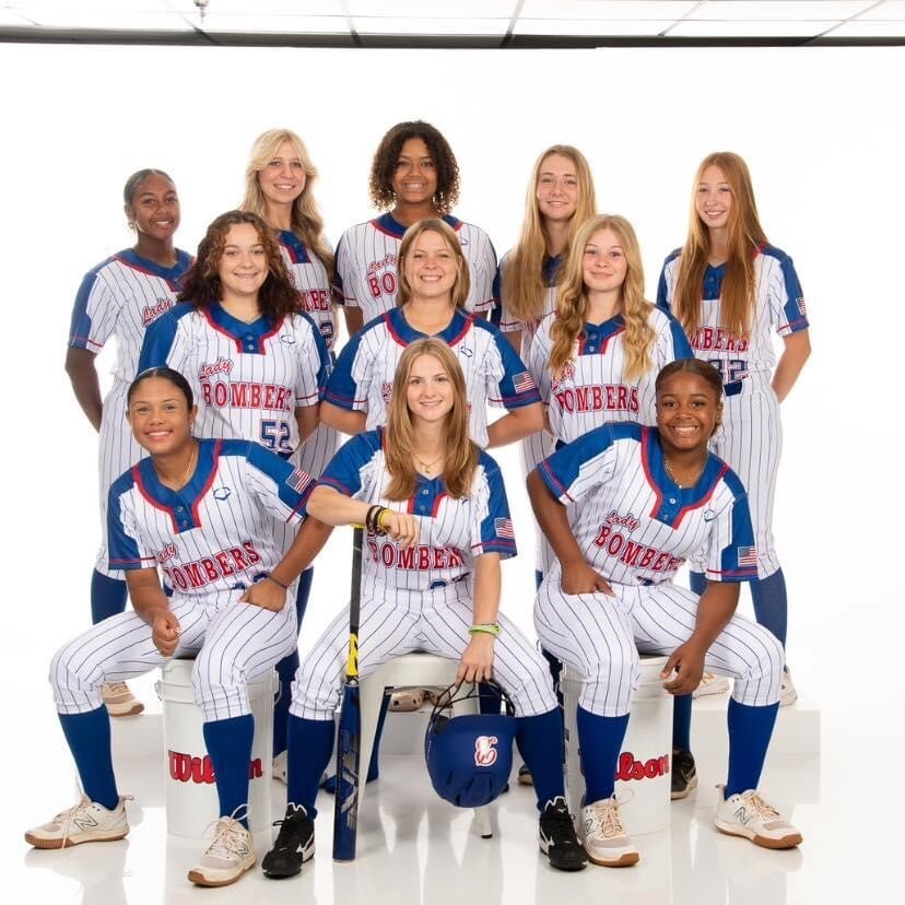 Youth softball team group photo with players posing together for CFY's youth sports program